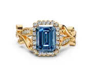 Halo Engagement Ring Setting for Fancy Blue Emerald Cut Center with Leaf Motif Split Shank and Prong Head in Yellow Gold