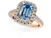 Halo Engagement Ring Setting for Fancy Blue Emerald Cut Center with Narrowing Pave Band and Prong Head in Rose Gold