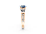 Channel-Set Engagement Ring Setting for Fancy Blue Round Cut Center with Baguette Band and Prong Head in Rose Gold