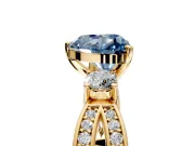 3 Stone Engagement Ring Setting for Fancy Blue Heart-Shaped Center with Pave Twist Band and Prong Head in Yellow Gold