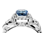 Halo Engagement Ring Setting for Fancy Blue Emerald Cut Center with Open Scroll Shoulders and Prong Head in Platinum
