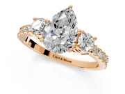 3 Stone Engagement Ring Setting for Pear-Shaped Center with Round Cut Side Accents and Prong Head in Rose Gold
