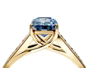 Solitaire Engagement Ring Setting for Fancy Blue Emerald Cut Center with Round Cut Channel Band and Prong Head in Yellow Gold