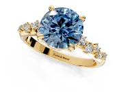 Solitaire Engagement Ring Setting for Fancy Blue Round Cut Center with Trailing Leaf Accent Band and Prong Head in Yellow Gold