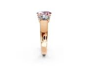 3 Stone Engagement Ring Setting for Fancy Pink Oval Center with Raised Basket Heads and Prong Head in Rose Gold