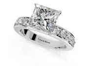 Solitaire Engagement Ring Setting for Princess Cut Center with Channel-Set Accents and Prong Head in Platinum