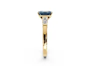 3 Stone Engagement Ring Setting for Fancy Blue Emerald Cut Center with Channel Baguette Accents and Prong Head in Yellow Gold