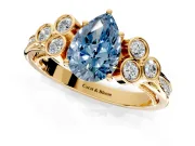 Cluster Engagement Ring Setting for Fancy Blue Pear-Shaped Center with Bezel Accent Clusters and Prong Head in Yellow Gold